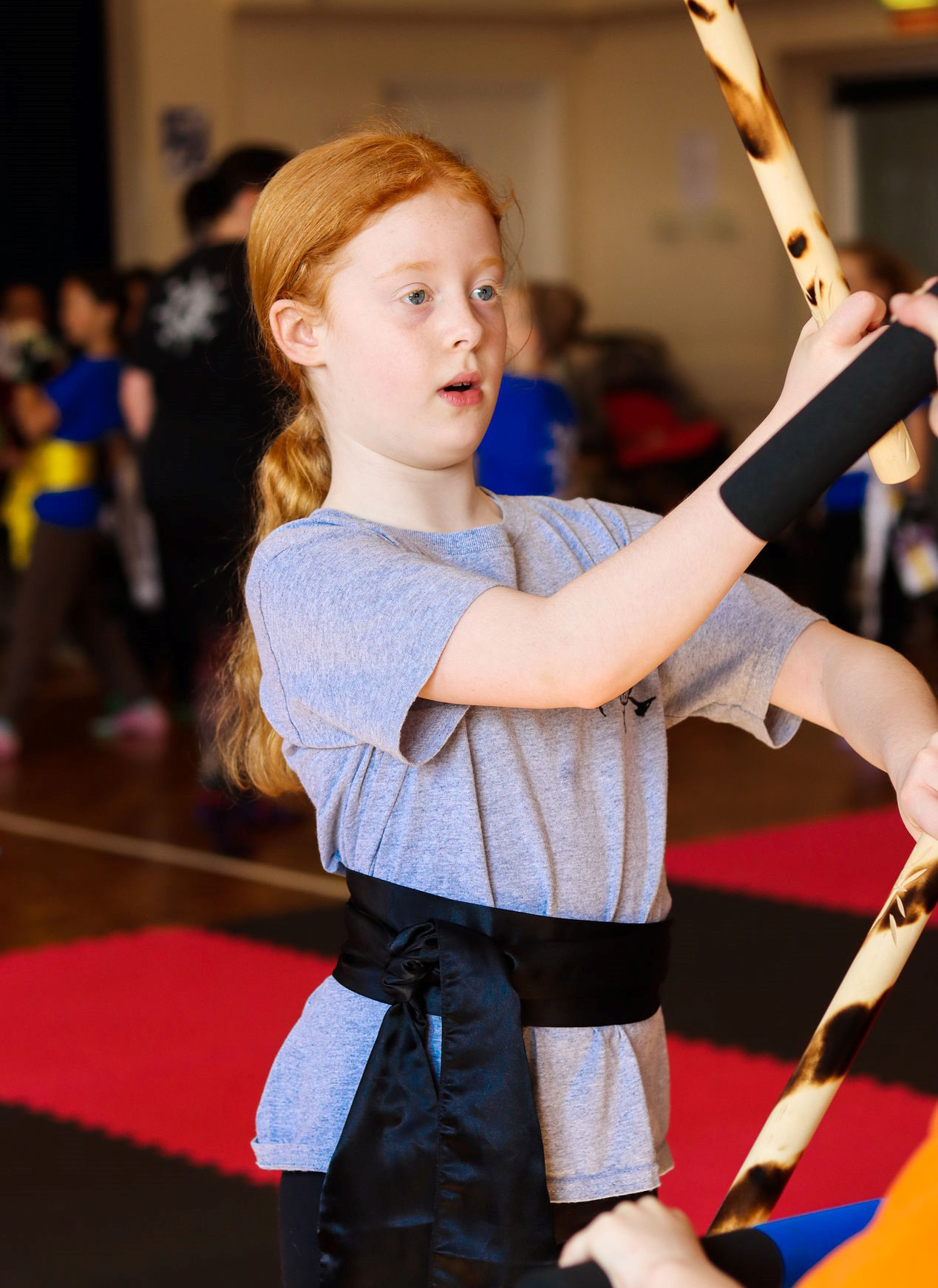 young student learning kung fu ESCRIMA STICK RATTAN TIGER CANE